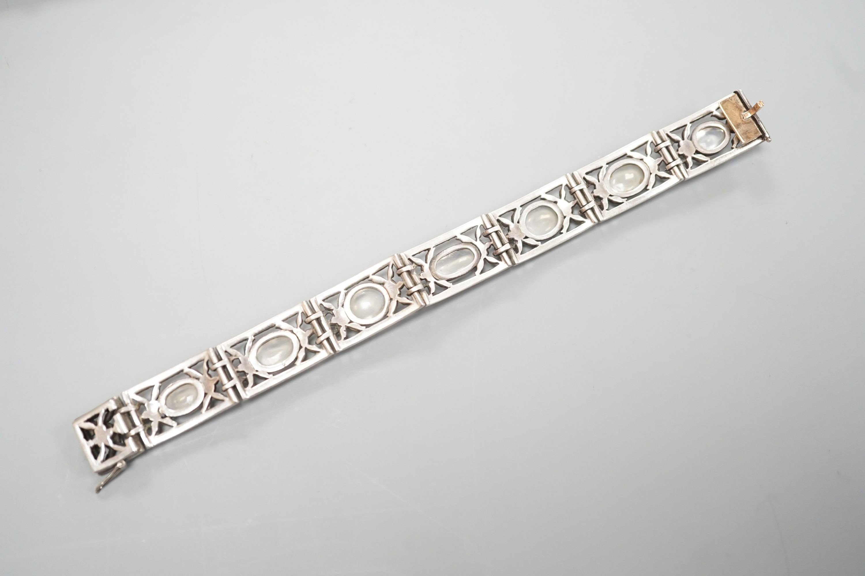 An early 20th century white metal, nine stone cabochon moonstone and marcasite set bracelet, 17.2cm.